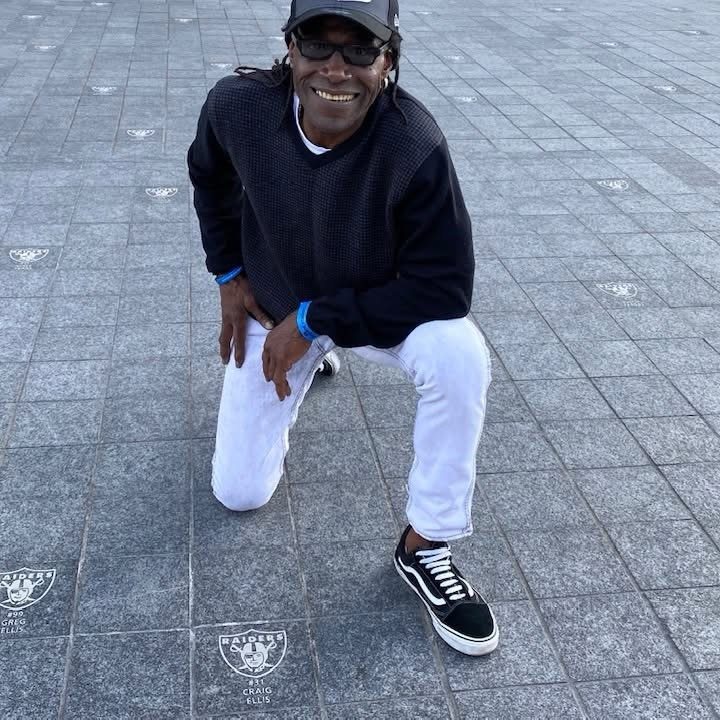 Craig Ellis beside his name plate at the Raiders plaza in Los Angeles